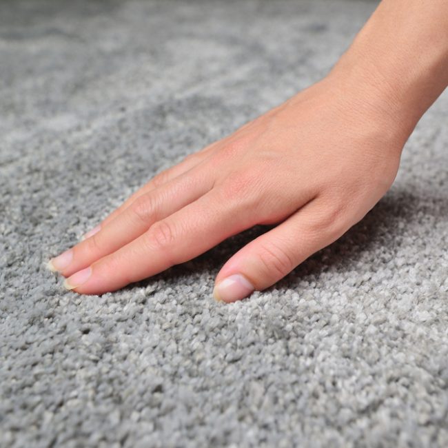Woman,Touching,Grey,Carpet,,Close,Up.,Close,Up,Of,Hand Dos and Don'ts: Tips on Cleaning Wool Rugs