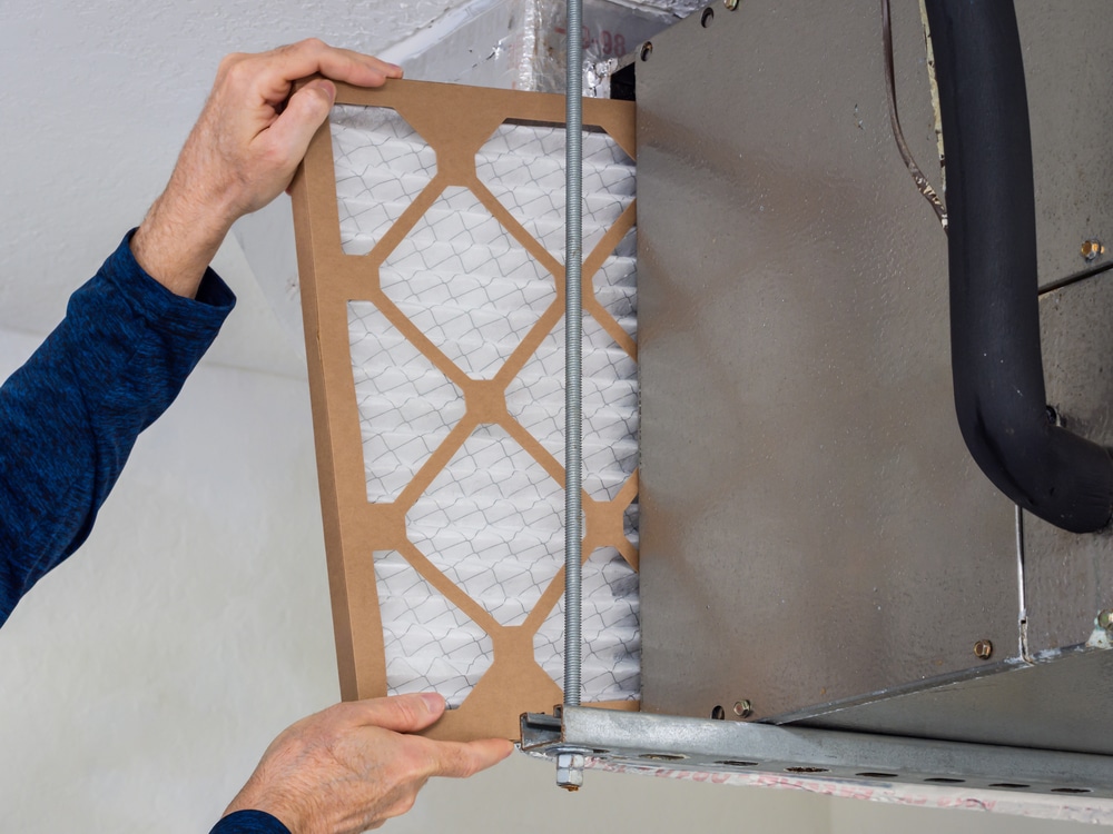 man hands changing HVAC air filter